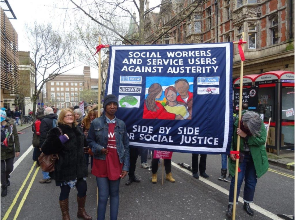 Person from Shaping Our Lives at a march. The banner besides them has the words 'Social Workers and Service Users against Austerity. Side by Side for Social Justice'. The banner has several organisation logos, one of which is Shaping Our Lives.'