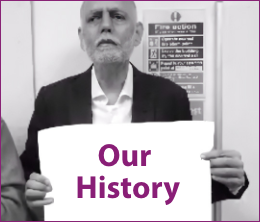 Person from Shaping Our Lives holding a banner with the words 'Our History'