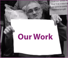 Person from Shaping Our Lives holding a banner with the words 'Our Work'