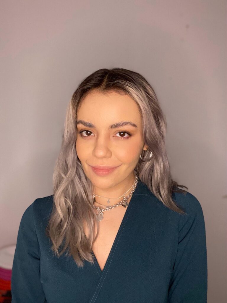 Ana-Maria Bilciu, a woman wearing a dark green top, smiling.