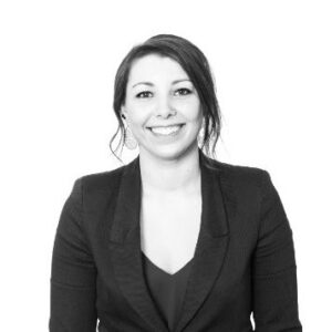 A photo of Alice Young - a woman with dark hair wearing a black blazer, smiling at the camera